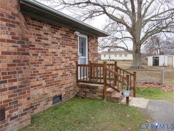a view of front door of house with a yard
