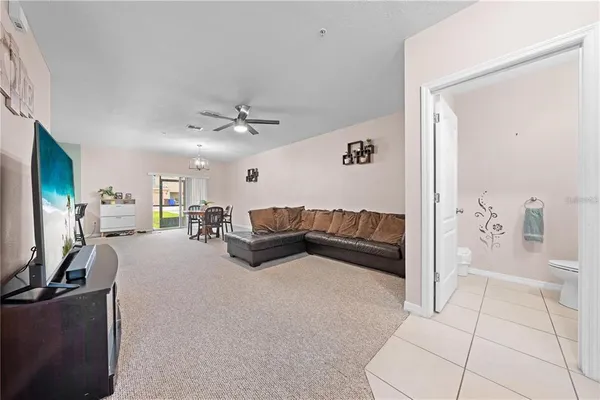 a living room with furniture a dining table and kitchen view