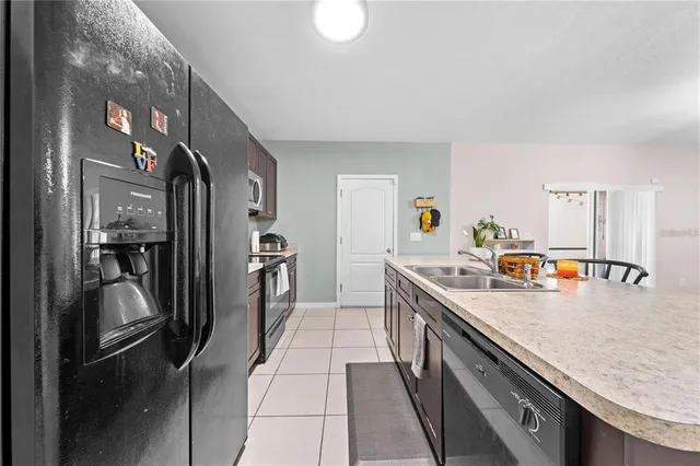 a kitchen with a sink and a refrigerator