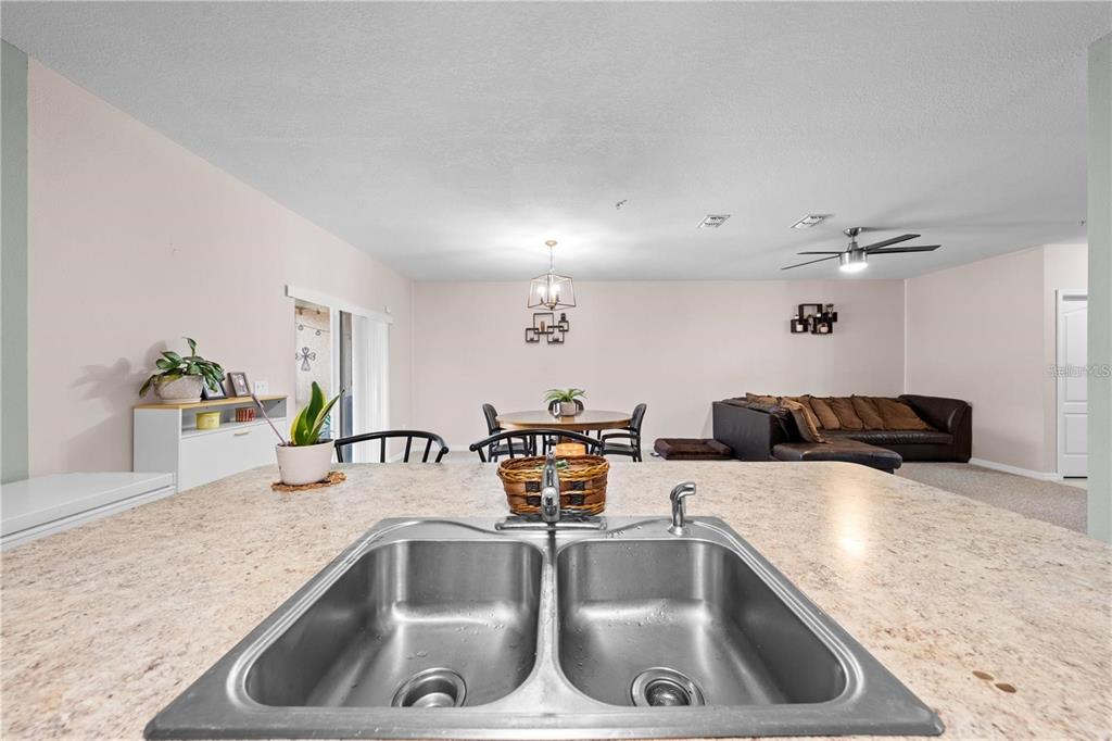 1619 Reflection Cove St. Cloud, FL 34771 - Photo 19 of 54 a kitchen with a sink and a refrigerator