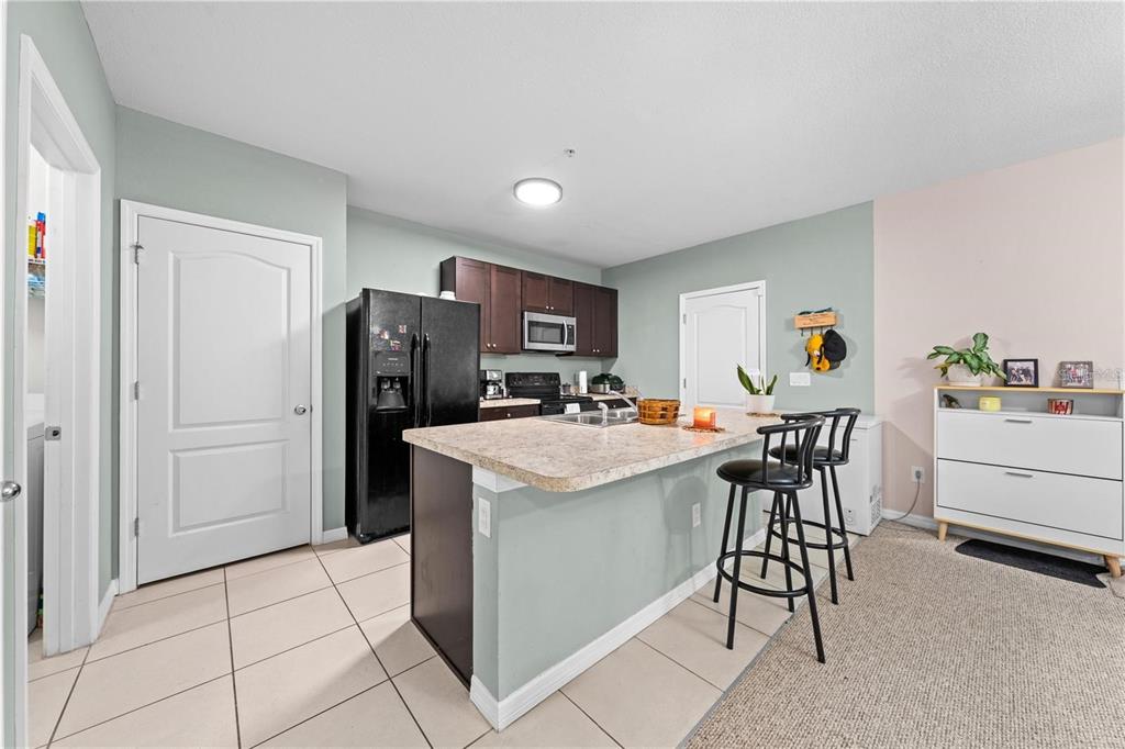 1619 Reflection Cove St. Cloud, FL 34771 - Photo 20 of 54 a kitchen that has a table and chairs in it
