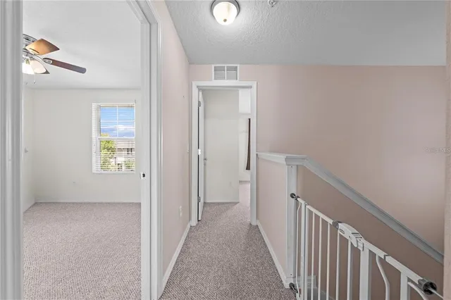 an empty room with a ceiling fan and a ceiling fan