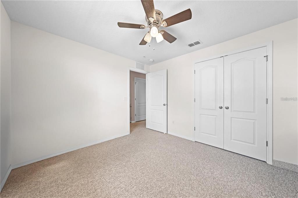 1619 Reflection Cove St. Cloud, FL 34771 - Photo 23 of 54 an empty room with a ceiling fan and a ceiling fan