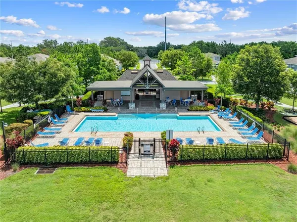 a front view of house with yard and swimming pool