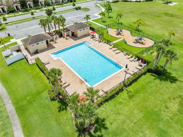an aerial view of a residential houses with yard