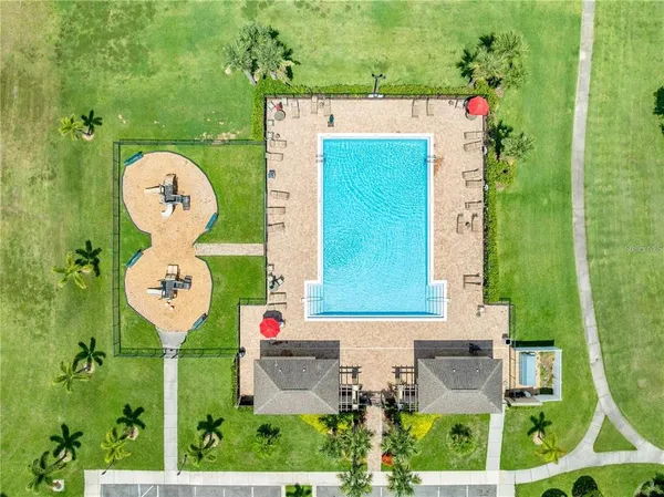 a view of a swimming pool with a yard and a garden