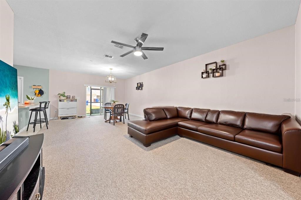 1619 Reflection Cove St. Cloud, FL 34771 - Photo 4 of 54 a living room with furniture