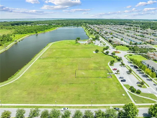 a front view of a house with a yard and potted plants