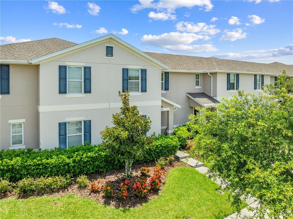 1619 Reflection Cove St. Cloud, FL 34771 - Photo 50 of 54 a front view of a house with a yard and outdoor seating
