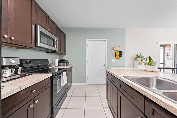 a kitchen with stainless steel appliances granite countertop a sink stove and cabinets