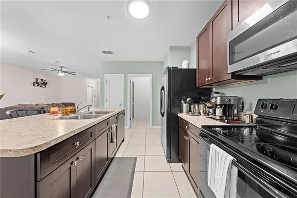 a kitchen with granite countertop stainless steel appliances and wooden cabinets