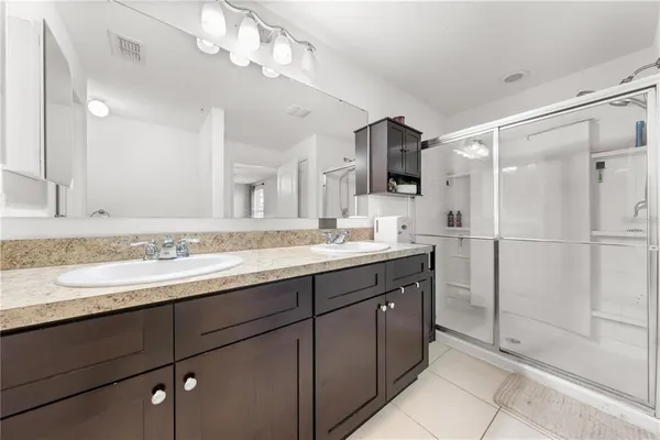 a bathroom with a sink double vanity and a shower