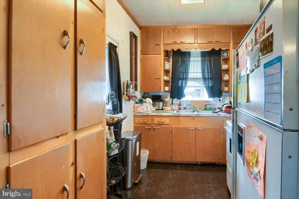 a room with water heater and wooden cabinets
