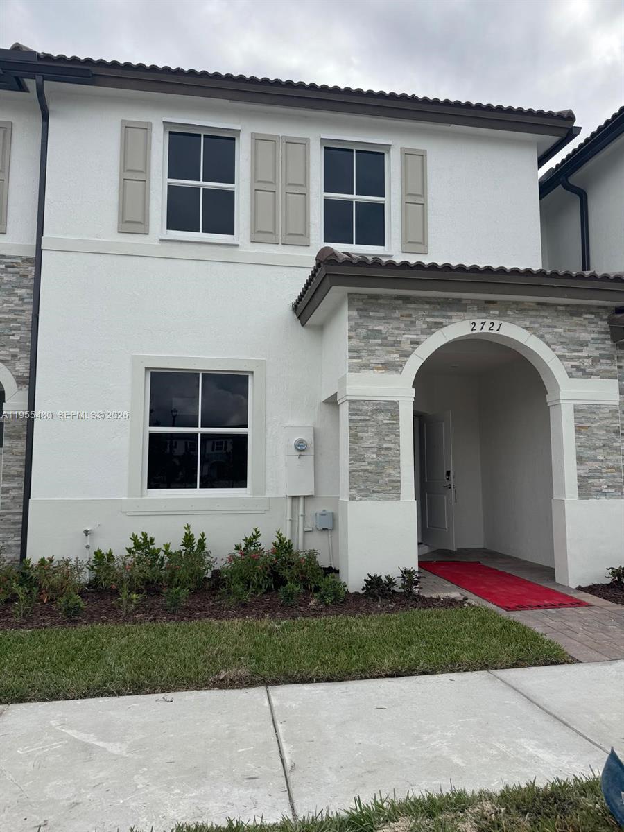 2721 Southeast 26th Road, Unit 2721 Homestead, FL 33035 - Photo 1 of 55 a front view of a house with a garden and yard
