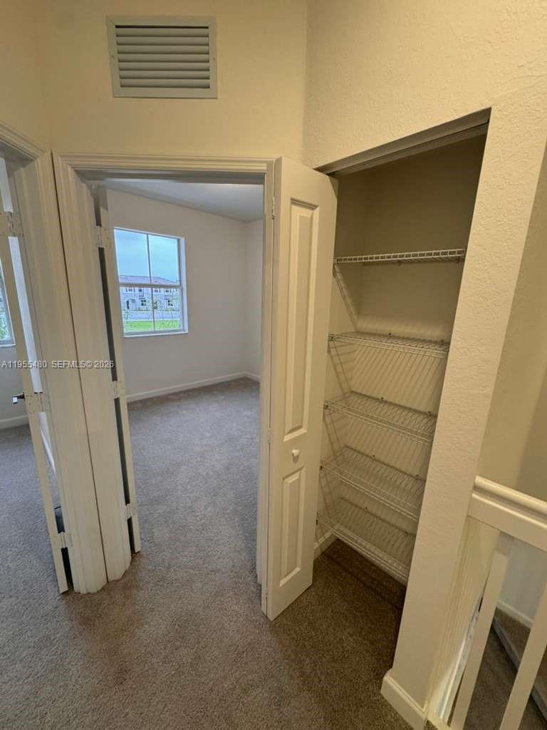 2721 Southeast 26th Road, Unit 2721 Homestead, FL 33035 - Photo 26 of 55 a view of room with a door and a hallway