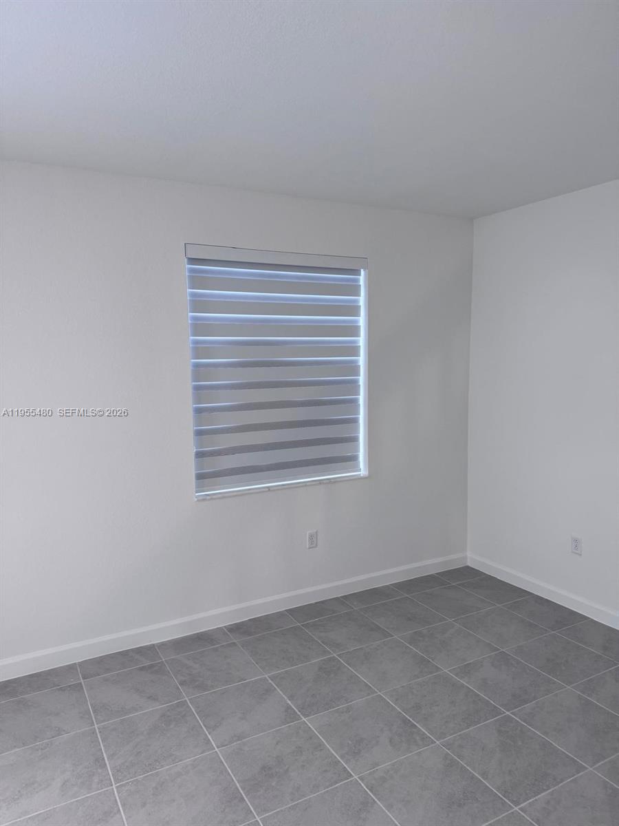 2721 Southeast 26th Road, Unit 2721 Homestead, FL 33035 - Photo 32 of 55 a view of an empty room with a window