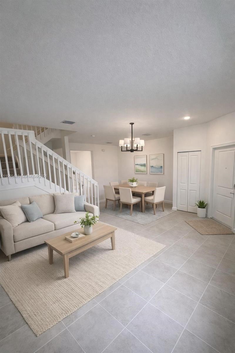 2721 Southeast 26th Road, Unit 2721 Homestead, FL 33035 - Photo 8 of 55 a living room with furniture and a chandelier