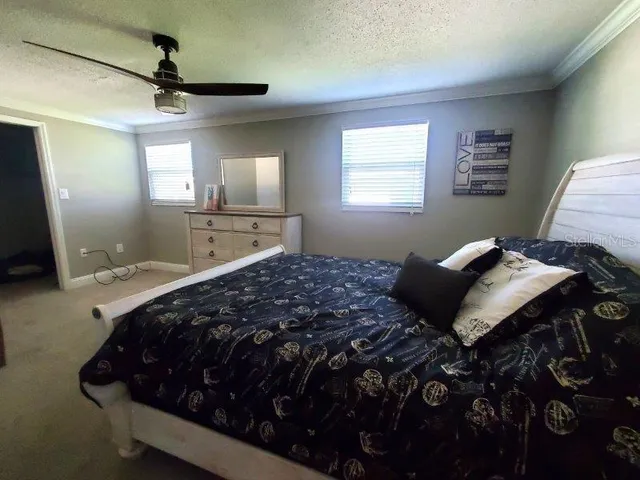 a view of walk in closet with clothes