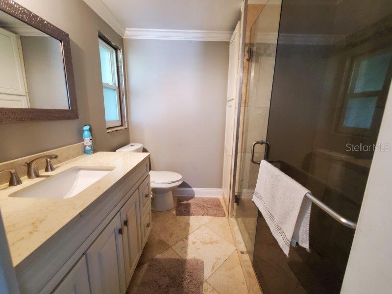22274 Westchester Boulevard Port Charlotte, FL 33952 - Photo 15 of 18 a bathroom with a sink a toilet and a mirror