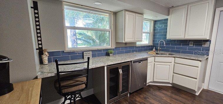 22274 Westchester Boulevard Port Charlotte, FL 33952 - Photo 16 of 18 a kitchen with a sink stove and cabinets