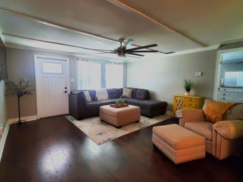 22274 Westchester Boulevard Port Charlotte, FL 33952 - Photo 2 of 18 a living room with furniture and a ceiling fan