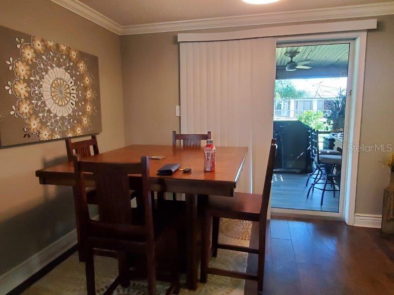 22274 Westchester Boulevard Port Charlotte, FL 33952 - Photo 5 of 18 a view of a dining room with furniture and wooden floor