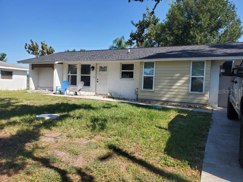22274 Westchester Boulevard Port Charlotte, FL 33952 - Photo 6 of 18 a view of a house with backyard sitting area and swimming pool