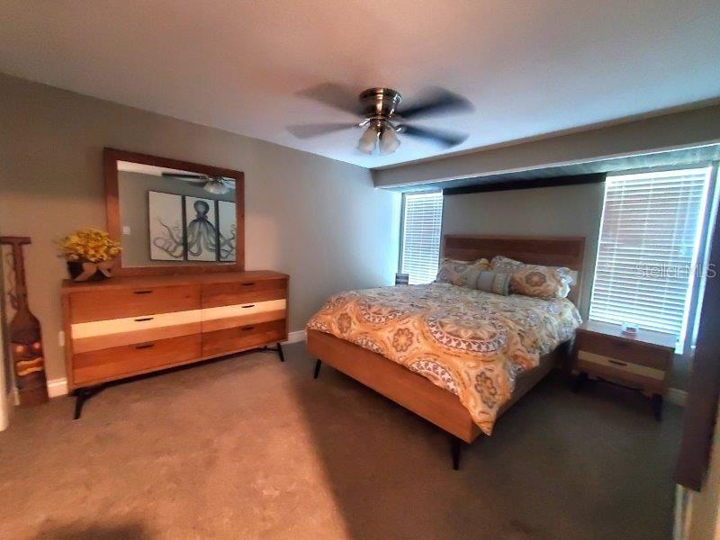 22274 Westchester Boulevard Port Charlotte, FL 33952 - Photo 10 of 18 a bedroom with a bed and a chandelier