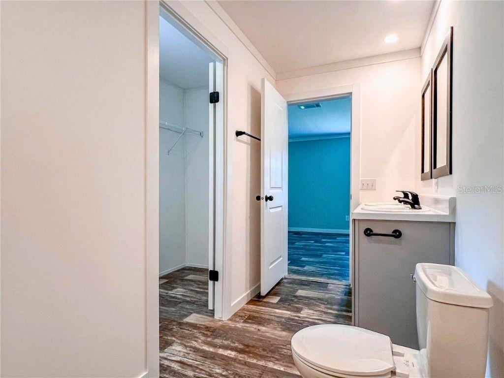 16108 Gupton Street Brooksville, FL 34613 - Photo 16 of 27 a bathroom with a granite countertop toilet sink and shower