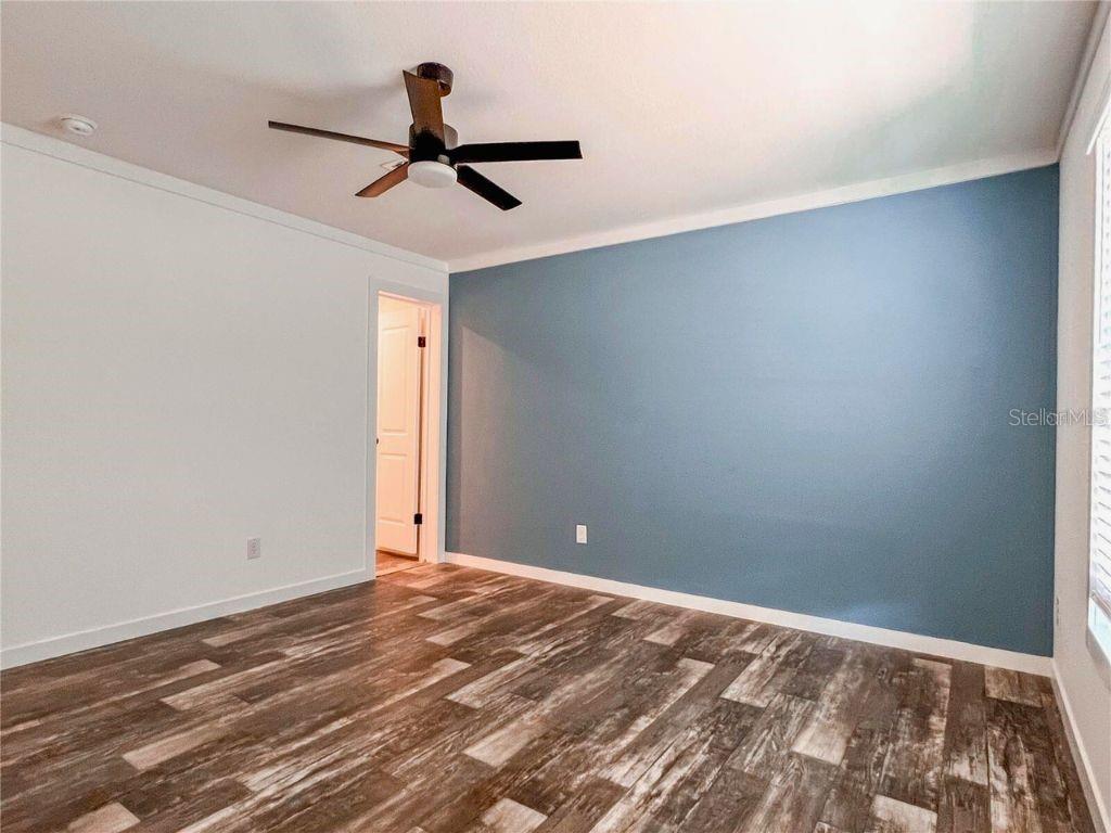 16108 Gupton Street Brooksville, FL 34613 - Photo 26 of 27 a view of a big room with wooden floor and windows