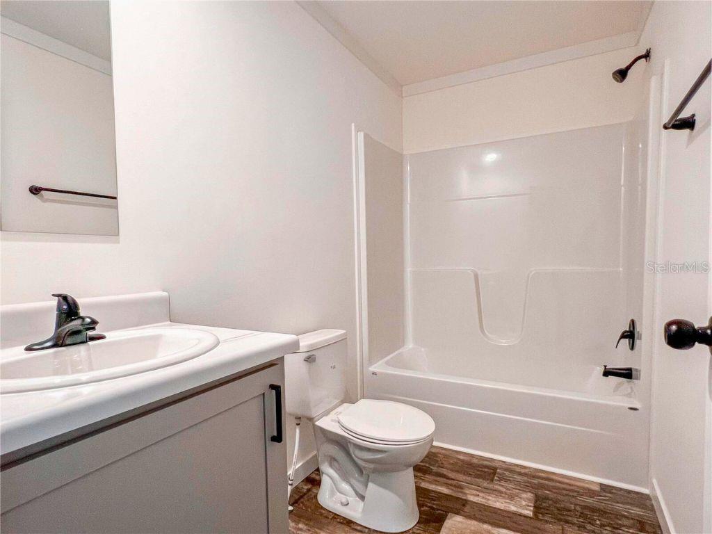 16108 Gupton Street Brooksville, FL 34613 - Photo 27 of 27 a bathroom with a sink a toilet and a bathtub