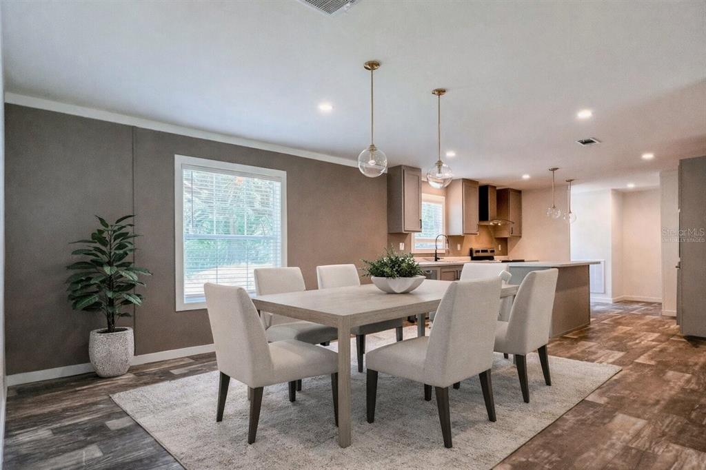 16108 Gupton Street Brooksville, FL 34613 - Photo 7 of 27 a view of a dining room with furniture window and wooden floor