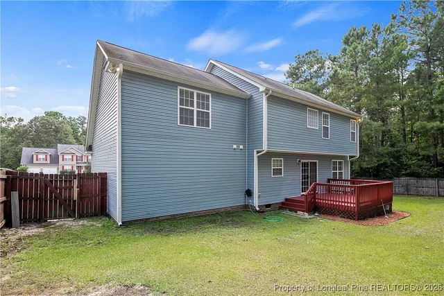 a view of a house with a backyard