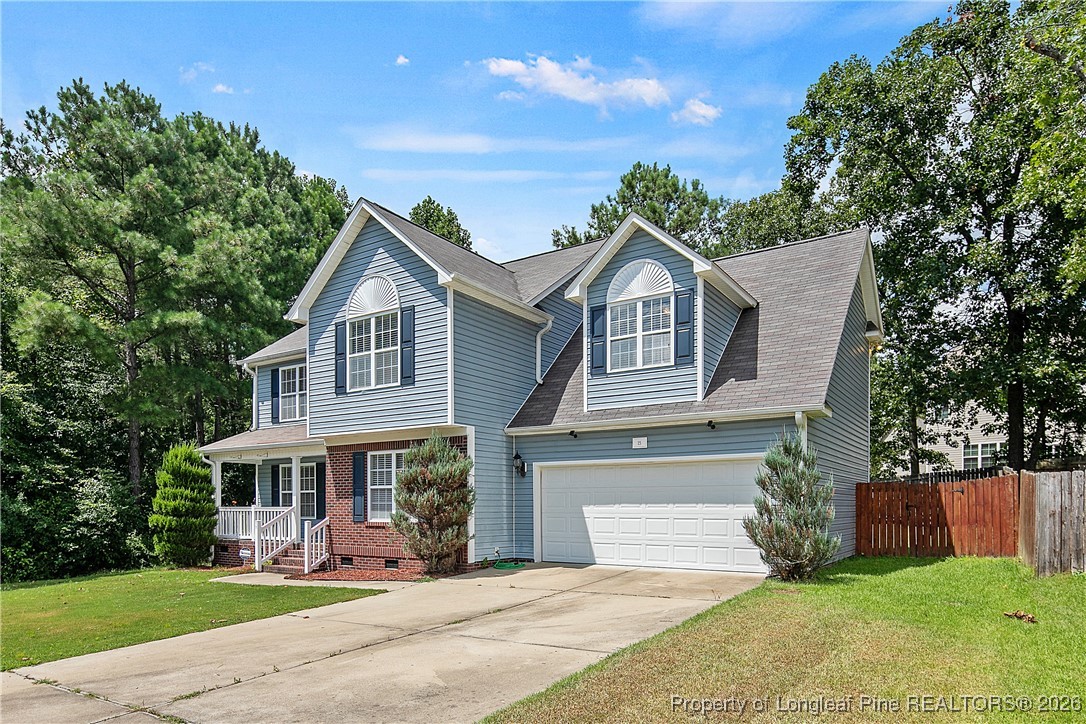 15 Rockingham Street Spring Lake, NC 28390 - Photo 2 of 15 a front view of a house with a yard and potted plants