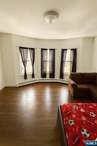 a living room with furniture and a floor to ceiling window