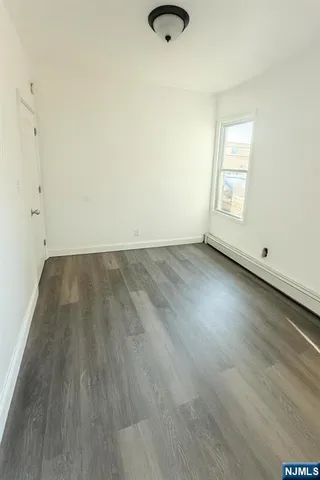 an empty room with wooden floor