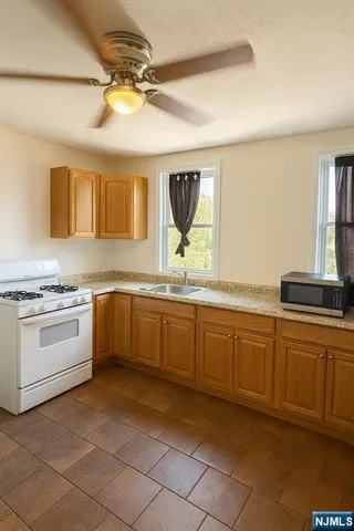 a large kitchen with a sink and cabinets