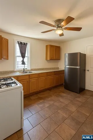 a kitchen with a cabinets and white stainless steel appliances