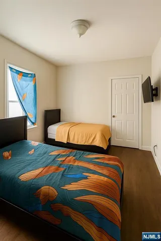 a bedroom with a bed and painting on the wall