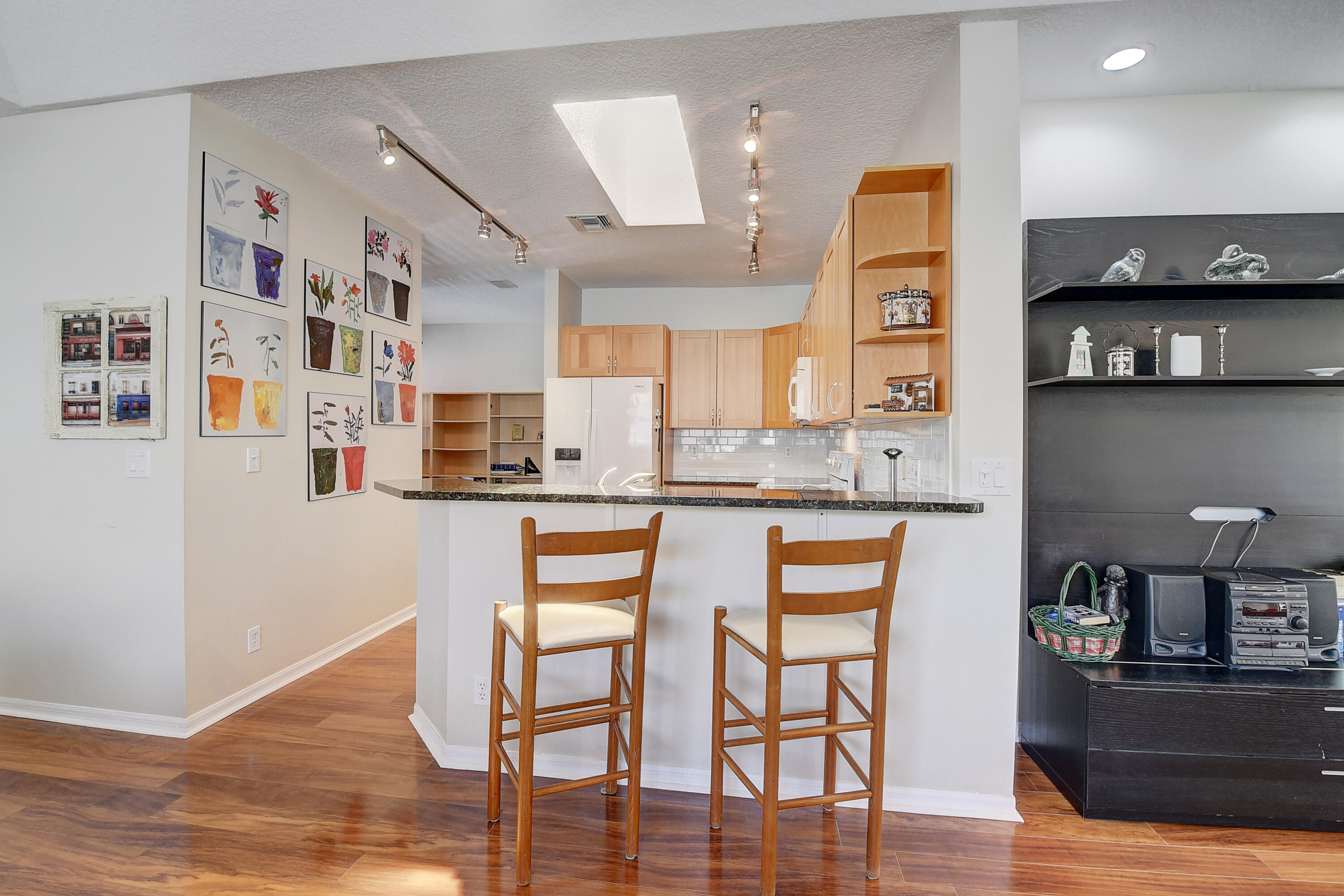 8652 Vía Reale, Unit 2 Boca Raton, FL 33496 - Photo 13 of 58 a kitchen with stainless steel appliances granite countertop a refrigerator and microwave