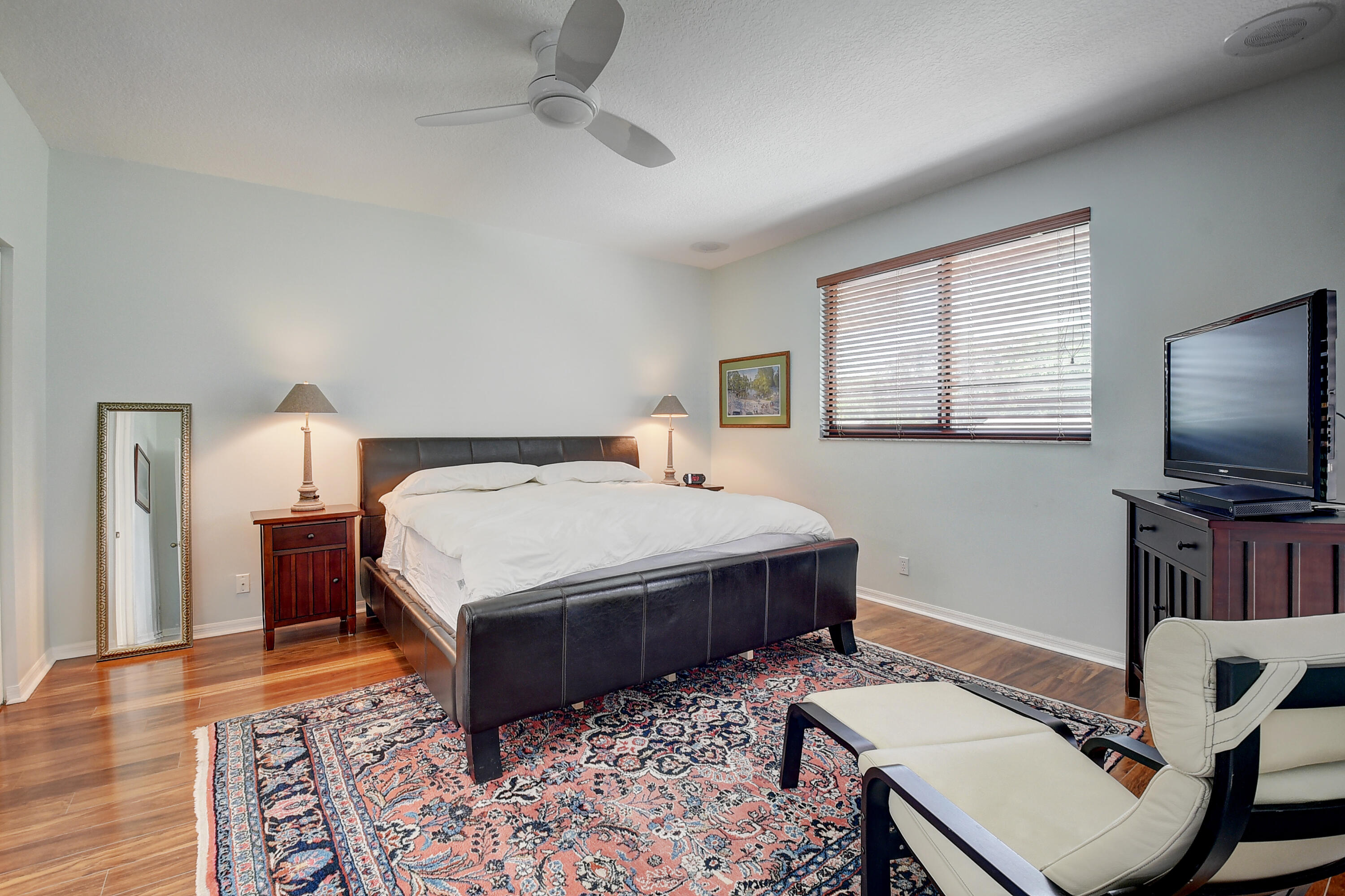 8652 Vía Reale, Unit 2 Boca Raton, FL 33496 - Photo 18 of 58 a bedroom with a bed and a flat screen tv