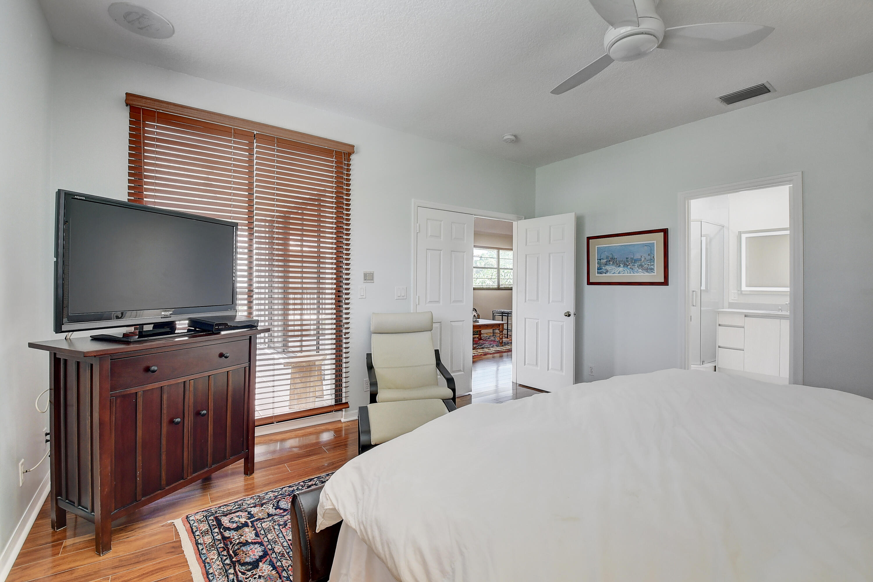 8652 Vía Reale, Unit 2 Boca Raton, FL 33496 - Photo 20 of 58 a bedroom with a bed and a flat screen tv
