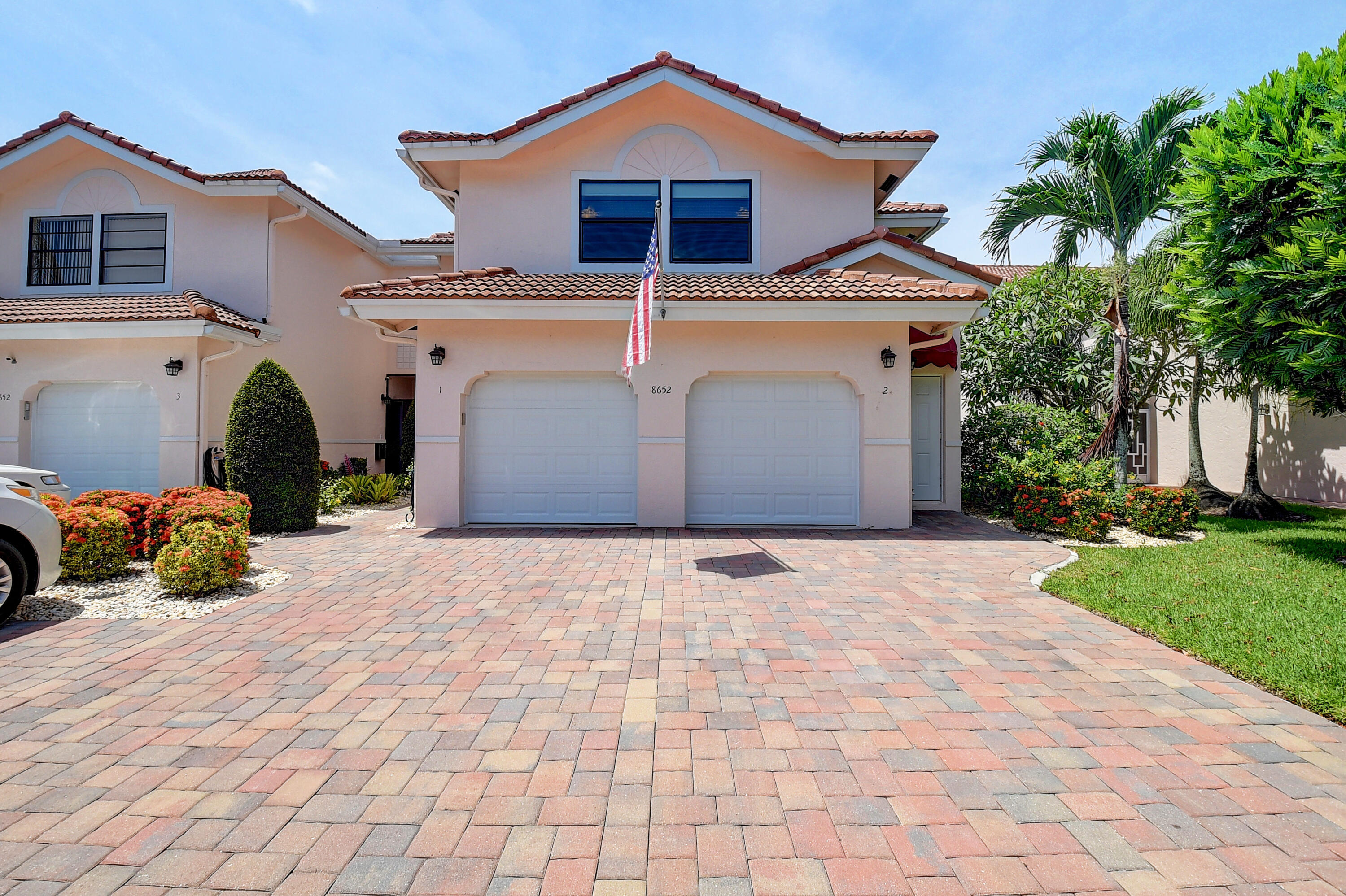 8652 Vía Reale, Unit 2 Boca Raton, FL 33496 - Photo 2 of 58 a front view of a house with garden