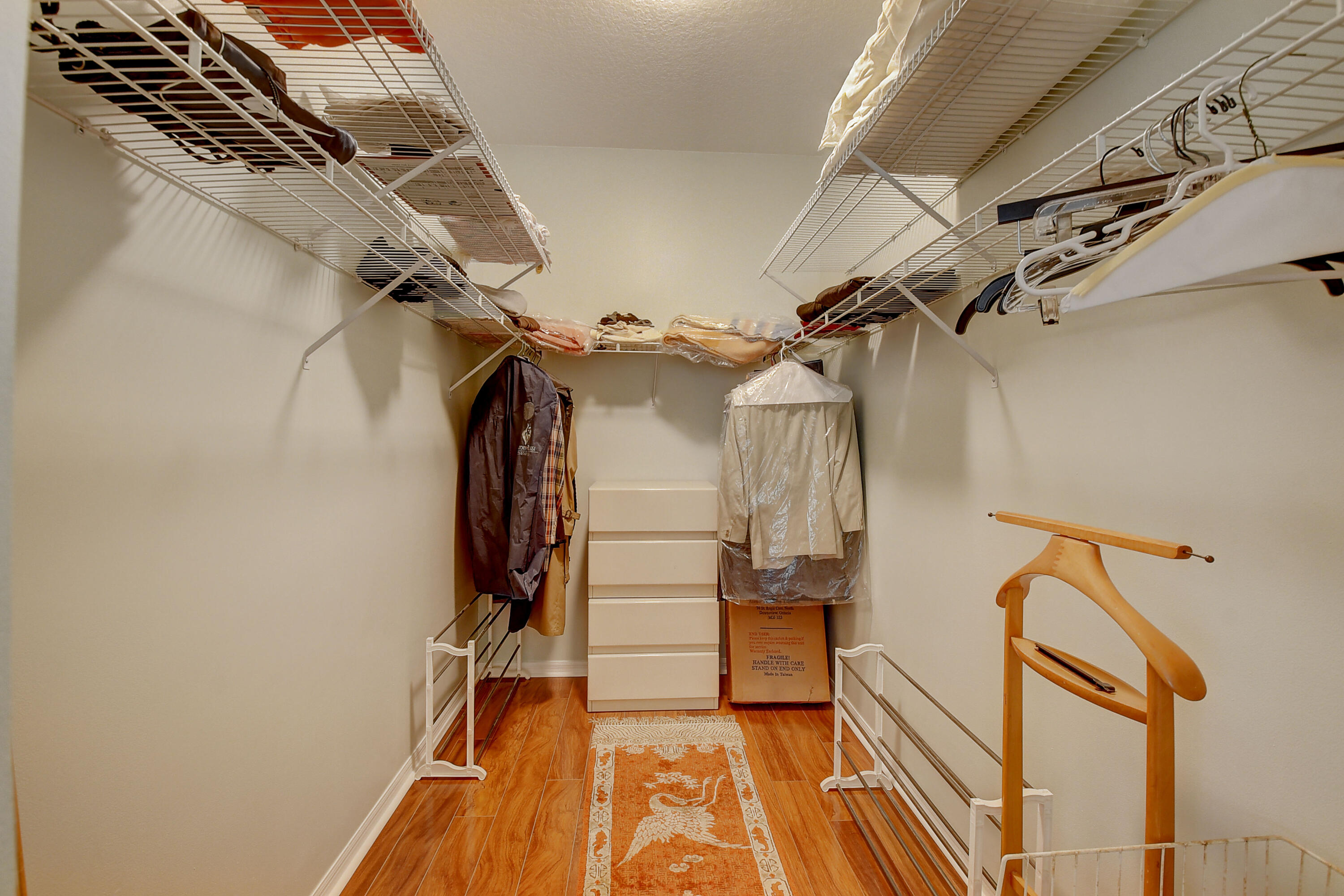 8652 Vía Reale, Unit 2 Boca Raton, FL 33496 - Photo 21 of 58 a view of walk in closet with clothes and shoes