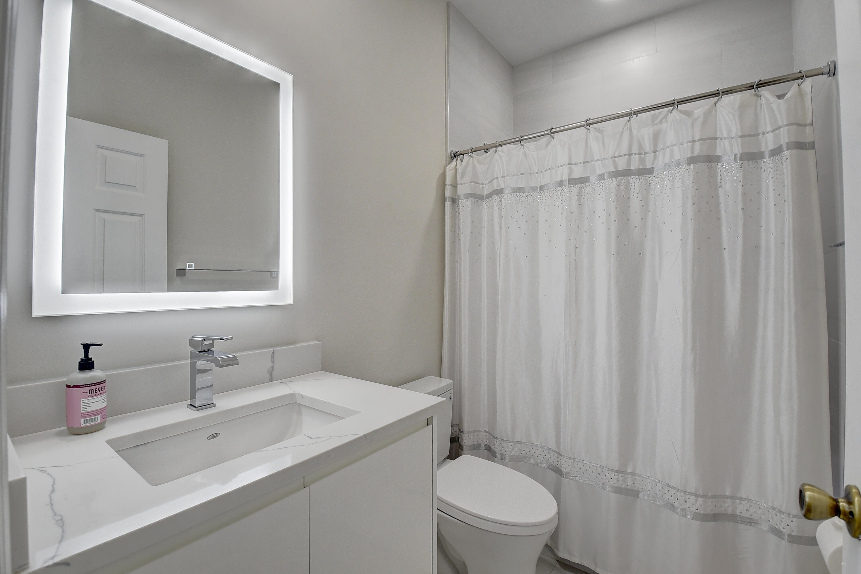 8652 Vía Reale, Unit 2 Boca Raton, FL 33496 - Photo 26 of 58 a bathroom with a sink a toilet and shower curtain