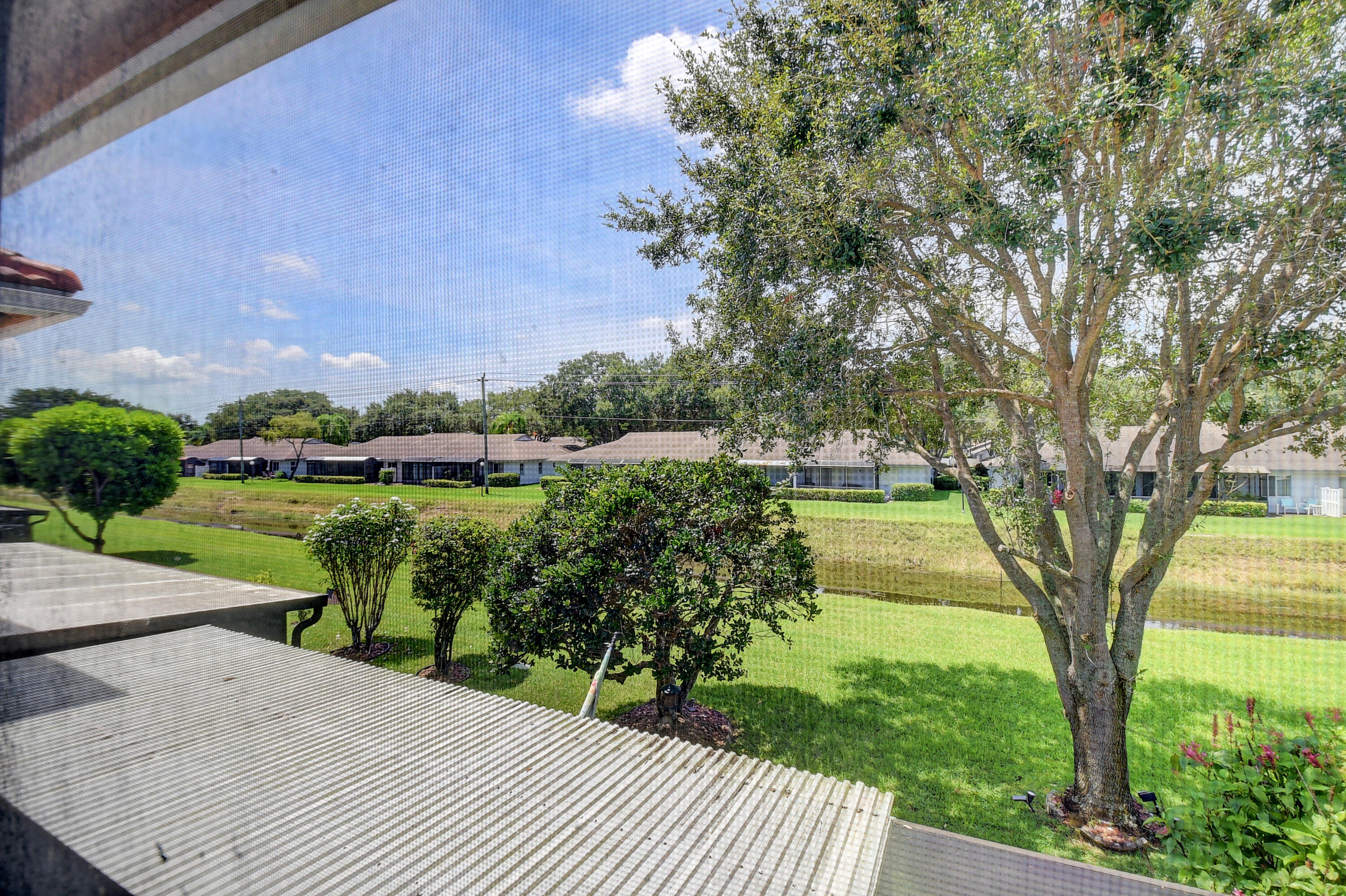 8652 Vía Reale, Unit 2 Boca Raton, FL 33496 - Photo 33 of 58 a view of a garden with a lake view