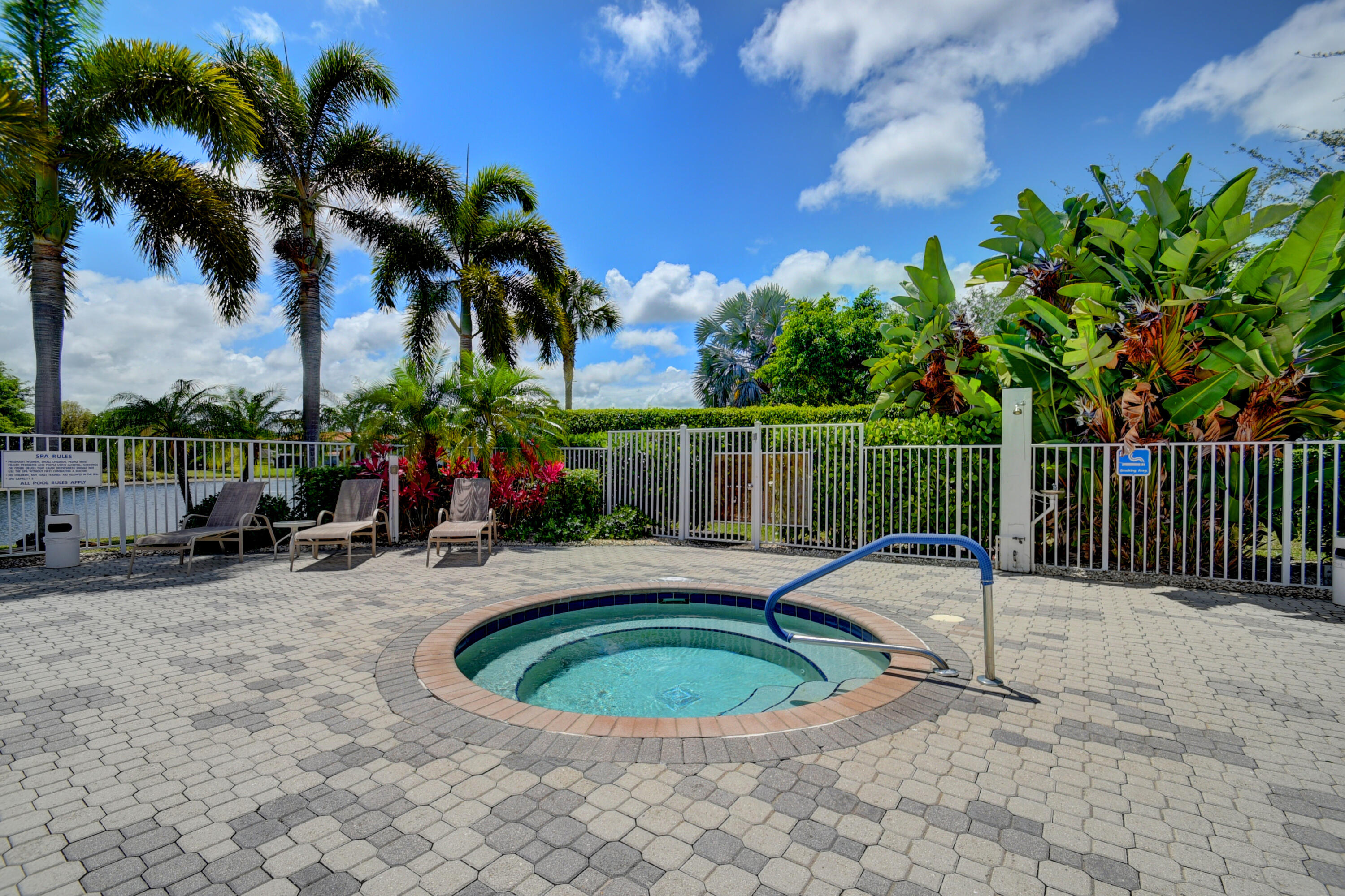 8652 Vía Reale, Unit 2 Boca Raton, FL 33496 - Photo 46 of 58 a view of a backyard with swimming pool and furniture