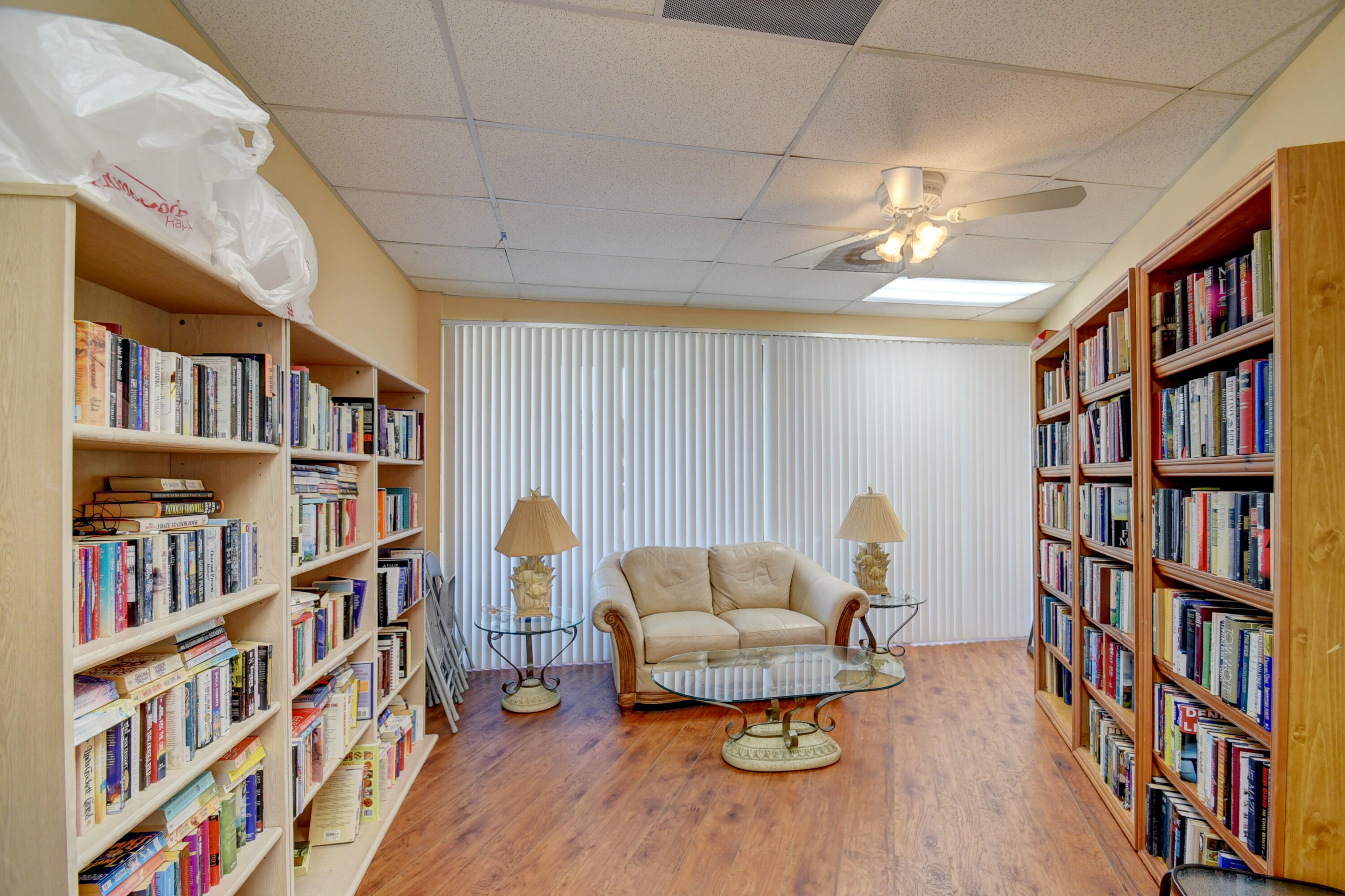 8652 Vía Reale, Unit 2 Boca Raton, FL 33496 - Photo 51 of 58 a living room with furniture and a book shelf