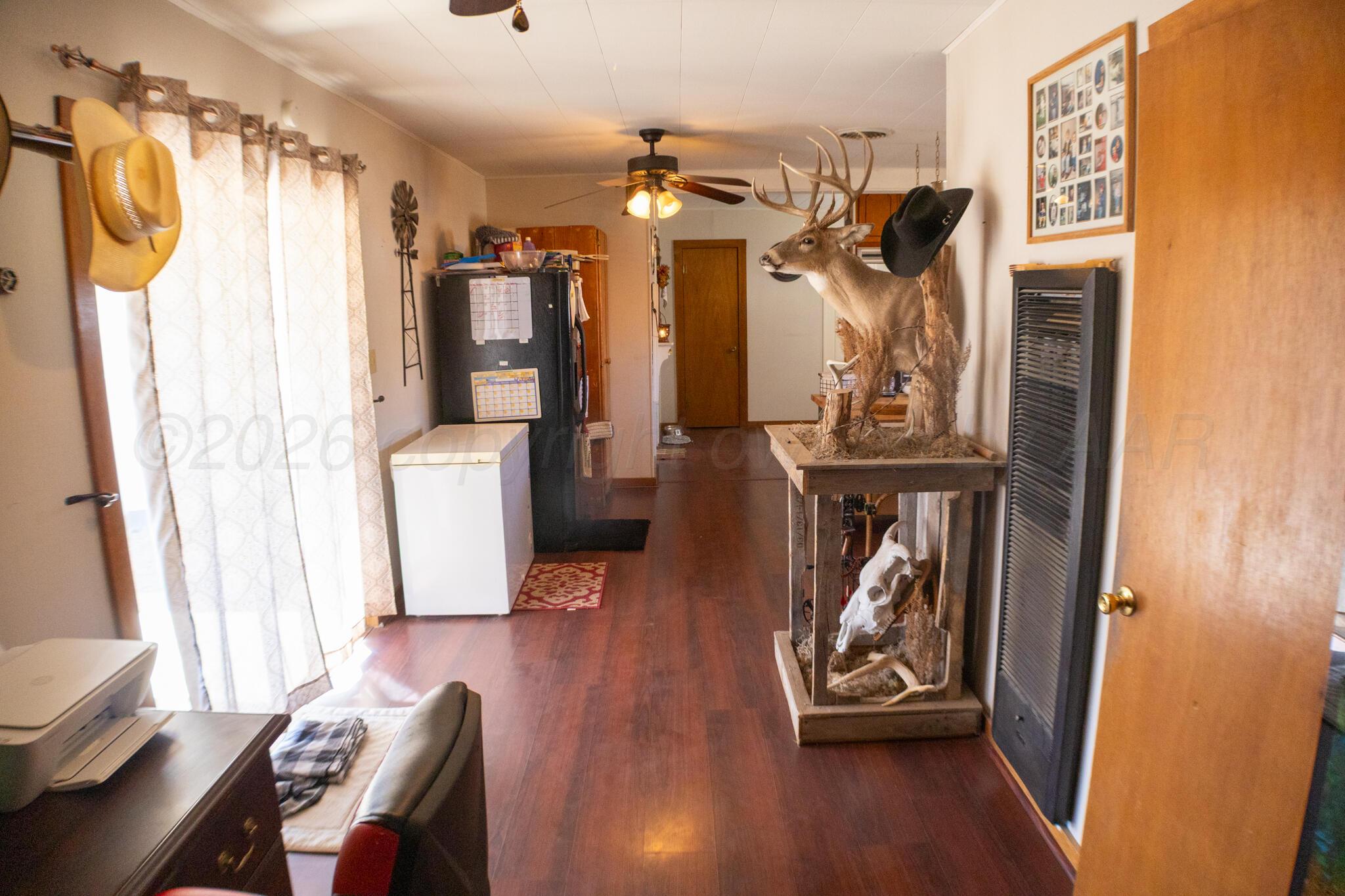 801 North Main Street McLean, TX 79057 - Photo 15 of 24 a view of a hallway with wooden floor and windows