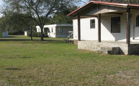96306 Blackrock Road Yulee, FL 32097 - Photo 1 of 6 a front view of house with yard